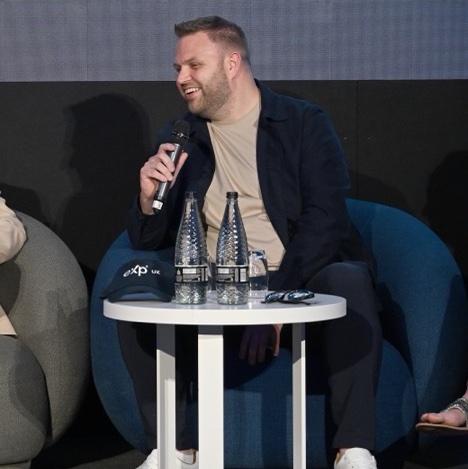 Michael speaking on stage at the eXp UK conference